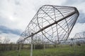 Radio astronomy observatory radio telescope construction in the fields in early spring in cloudy weather