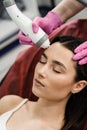 Radio frequency lifting for young woman. Dermatologist is doing radio frequency RF skin tightening. RF facelift firms Royalty Free Stock Photo