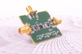 Radio frequency mixer PCB in front of Smith chart Royalty Free Stock Photo