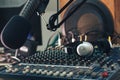 Radio host microphone, mixing console and headphones close-up