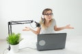 Radio host, streamer and blogger concept - Woman working as radio host at radio station sitting in front of microphone Royalty Free Stock Photo