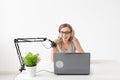 Radio host, streamer and blogger concept - Woman working as radio host at radio station sitting in front of microphone Royalty Free Stock Photo