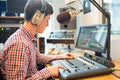 Radio host using sound mixer in studio Royalty Free Stock Photo