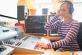 Radio host wearing headphones using sound mixer Royalty Free Stock Photo