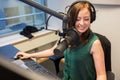 Radio Jockey Smiling While Wearing Headphones In Studio