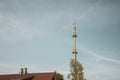 Radio mast for the mobile phone network towers above a residential building into the blue sky in a residential area Royalty Free Stock Photo