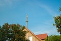 radio mast for the mobile phone network towers above a residential building into the blue sky in a residential area Royalty Free Stock Photo