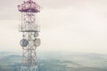 Radio mast over a cloudy valley Royalty Free Stock Photo
