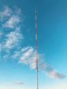 USA - A tall red & white radio & TV tower rockets to the sky in front of a blue sky and white clouds - PARMA - OHIO Royalty Free Stock Photo