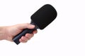 Radio microphone in the hand of a reporter doing an interview isolated on a white background Royalty Free Stock Photo