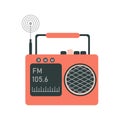 The radio is orange, vintage, with a radio wave on a small screen, a pressed button, an antenna and a carrying handle.