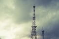 Radio telecommunications tower, Mobile phone tower and old steel pipe in storm clouds. dramatic landscape with cloud storm cloud a Royalty Free Stock Photo