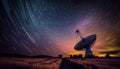 Radio telescope antenna radio receiver on beautiful night sky with star trails copy space Royalty Free Stock Photo