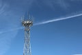 Radio tower with antennas on a blue sky background. Metal construction. Technology building. The technology of wireless informatio Royalty Free Stock Photo