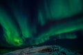 Radio tower on the hill and the Northern lights over the fjord Royalty Free Stock Photo