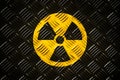 Radioactive ionizing radiation round yellow and black danger symbol painted on a massive steel checker metal diamond plate Royalty Free Stock Photo