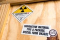 Radiation label beside the transport wooden box Type A package