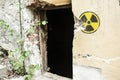 Radioactive warning sign on the grunge dirty wall in abandoned building from the exclusion zone. Chernobyl Pripyat atmosphere