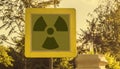 a Radioactivity and chemical hazard street sign with toxic clouds on the background: pollution and danger concept