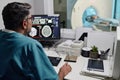 Radiographer Controlling CT Scanner At Work In Hospital Royalty Free Stock Photo