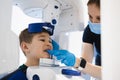 Radiographer taking panoramic teeth radiography to a little boy using modern x-ray machine.