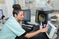 Radiologic technician monitoring mri scan