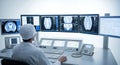 Radiologist Analyzing Brain Scans on Multiple Monitors in a Brightly Lit Medical Office with White Walls and Modern Medical Royalty Free Stock Photo