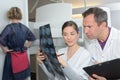 Radiologist woman checking x-ray with co-worker