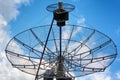 Radiotelescope on cloudy blue sky background