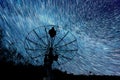 Radiotelescopes silhouettes under short star trails