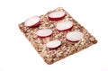 Radish on crispy bread. Stack of wholegrain crispy bread with sunflower, chia and sesames seeds on white background. Royalty Free Stock Photo