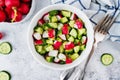 Radish cucumber salad with greens in bowl Royalty Free Stock Photo