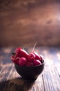 Radish fresh in a plate on a wooden blurry background