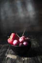 Radish fresh in a plate on a wooden blurry background