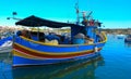 raditional eyed colorful boats Luzzu in the Harbor of Mediterranean fishing village