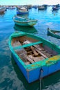 raditional eyed colorful boats Luzzu in the Harbor of Mediterranean fishing village