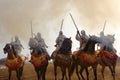 Raditionally dressed Moroccan tribals and horsemen riding the horses and fire the rifles