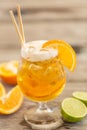 Radler with ice, paper straws and orange wedges Royalty Free Stock Photo