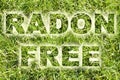 Radon free: land free from the natural dangerous radioactive gas that comes from the earth - concept image with text over a green