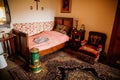 Radun castle interior, Neo-Classical chateau, bedroom, single bed, bedside table with photos, soft velvet embroidered armchair,