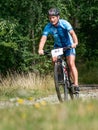 Blue jersey rider move along the distance overcoming the descents