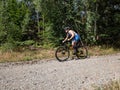 Sportsman with compressing tights brakes before turn in forest