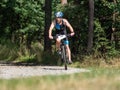 Triathlon racer turns after long descent through the forest