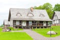 RADVILISKIS, LITHUANIA - JUNE 12, 2014: Unique Village and Rural Area in Lithuania with Wooden Building and Green Grass