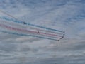 RAF Red Arrows in action with coloured smoke Royalty Free Stock Photo