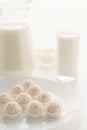 Raffaello candy in baskets on a plate, with milk in a glass and