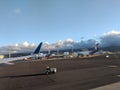 raffic car drives down runway as Hawaiian Airlines Planes parked at Honolulu International airport Royalty Free Stock Photo