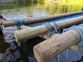 Raft building team work with logs tied together with rope