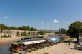 Raft restaurant on river Nisava and a quay promenade on summer sunny day