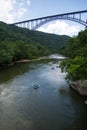 Rafters heading under the New River Gorge Bridge Royalty Free Stock Photo